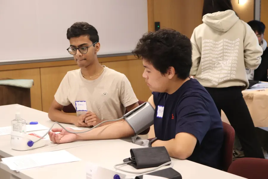Penn students practice taking a blood pressure reading