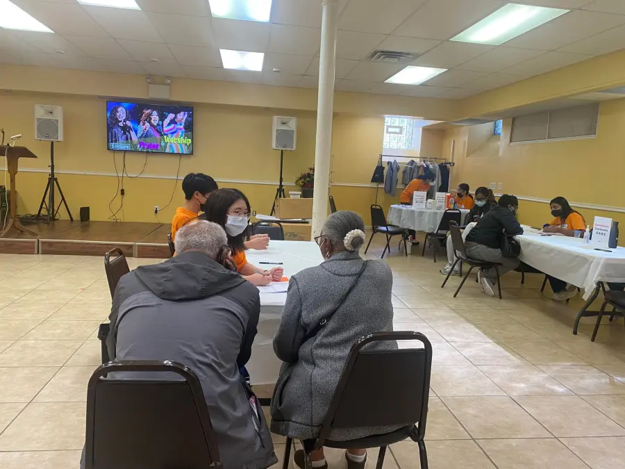 Penn KDSAP volunteers speak with community members at a screening